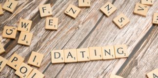 15 Modern Dating Terms Unmasking What Love Looks Like Today Scrablle pieces spelling out the word dating and others representing modern dating terms