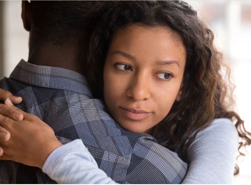 a woman hugs her partner as she ends the relationshiup