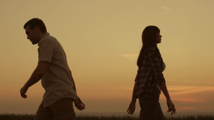 man and woman walking away after a breakup