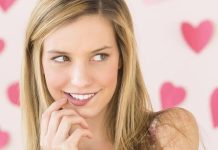 15 Eye-Opening Signs She’s Interested in You and How to Make Your Move Girl with a teasing smile as a sign she's interested in you