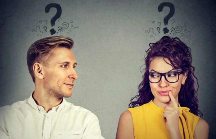 A man wondering how to hsow he's interested and a woman wondering the signs that he's interested