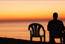 Feeling Lonely in a Relationship? Here’s What You Can Do to Feel Close Again A man Seating alone iwith an emtpty chair next to him showing how one can be lonely in a relationship